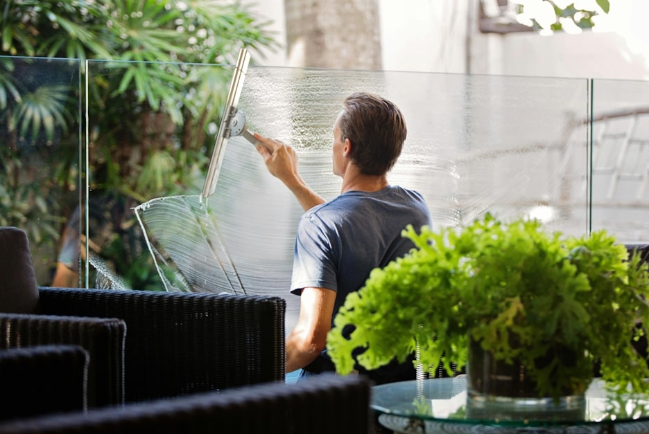 Cleaner cleaning windows in a commercial space.