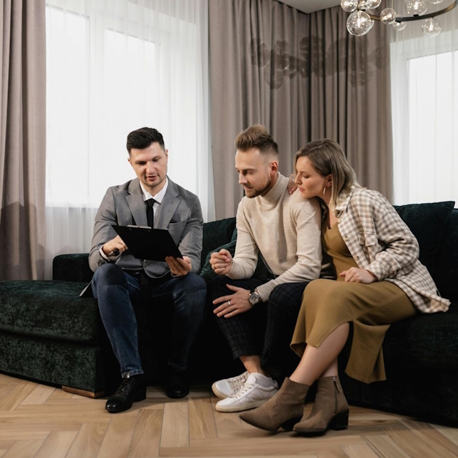 Leasing agent discussing rental terms with potential tenants.